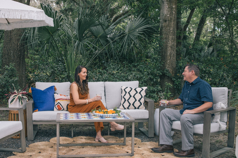 Woman and man sitting in outdoor patio with DIY tiled coffee table