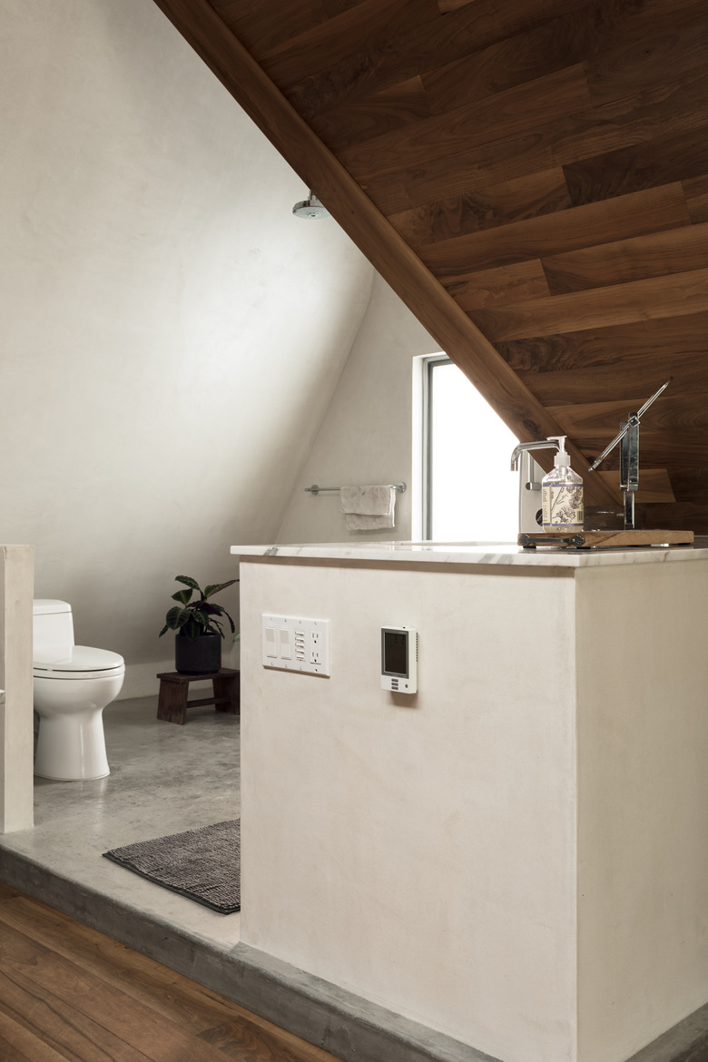 view of bathroom with toilet and wood-paneled ceiling