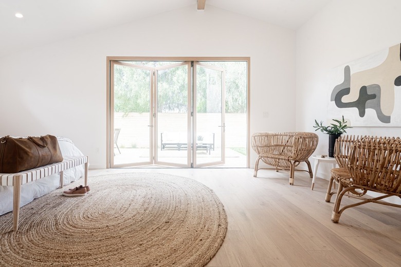 Minimalist white walled bedroom with beige-white color theme