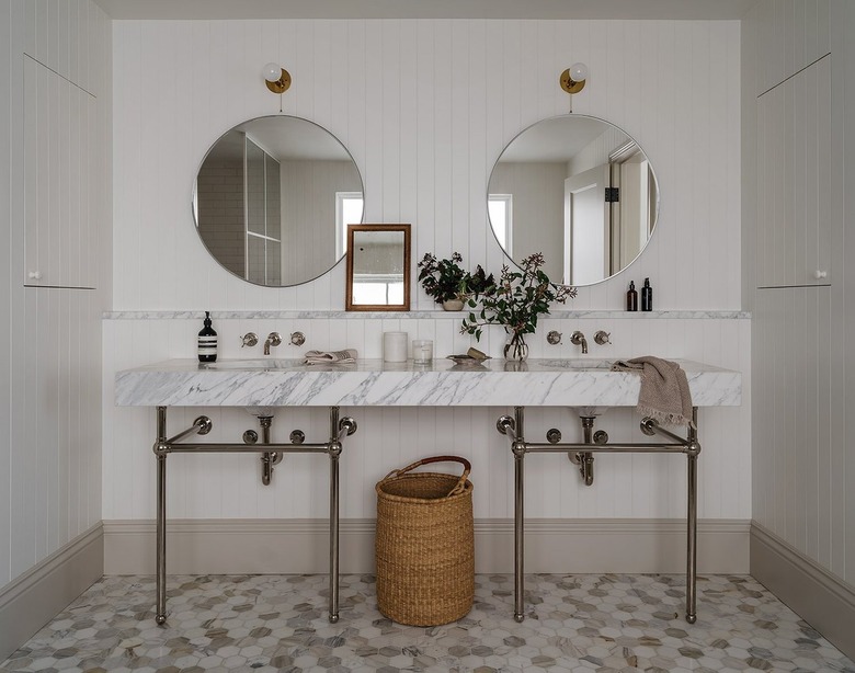 muted bathroom with double marble exposed leg vanity