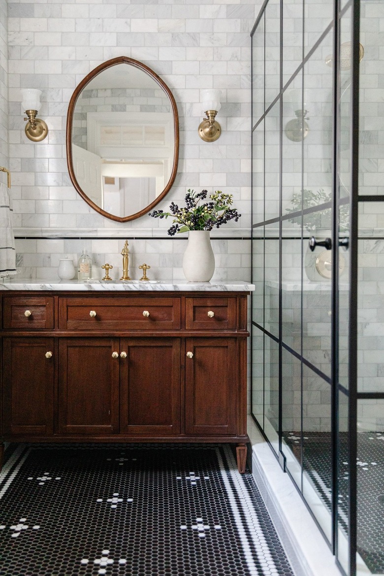 traditional bathroom with penny tile floor and gridded shower surround