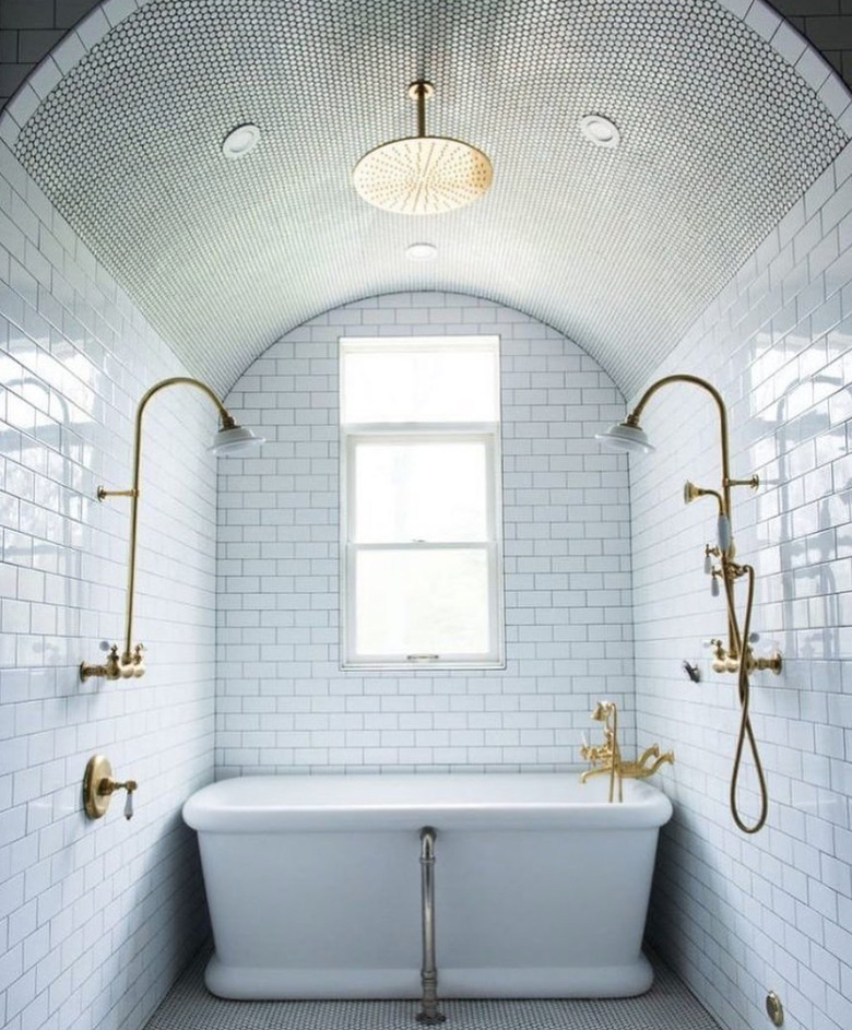 traditional bathroom idea with all-over tiled white bathroom