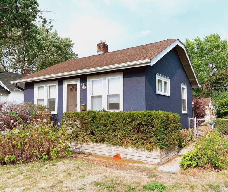 purple cottage with wood accents