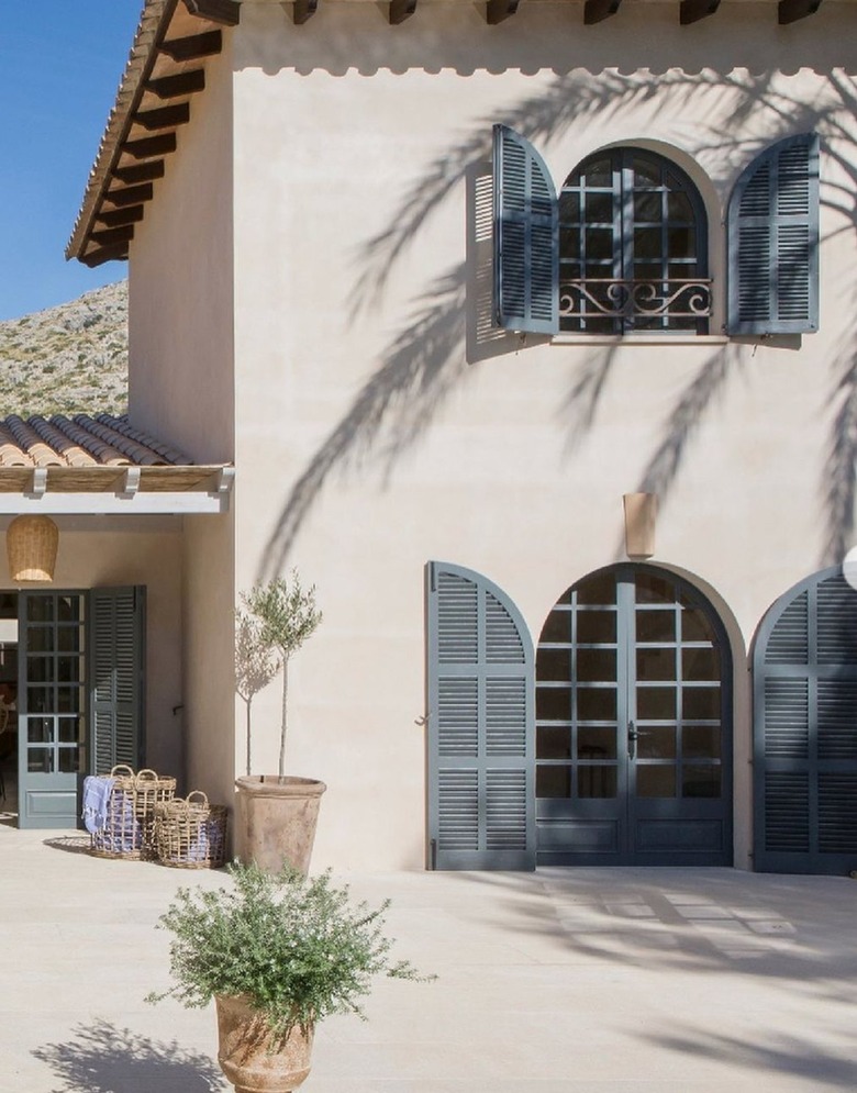 tan mediterranean home with blackened trim