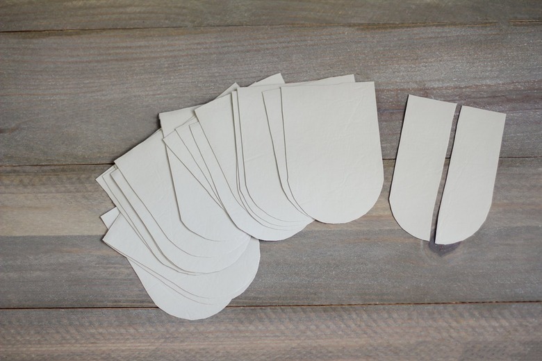 Leather cut in scallop shapes on wood background