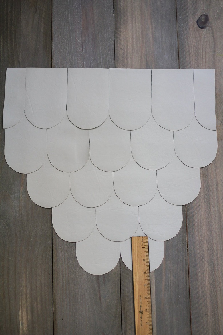Leather scallops with ruler on wood floor