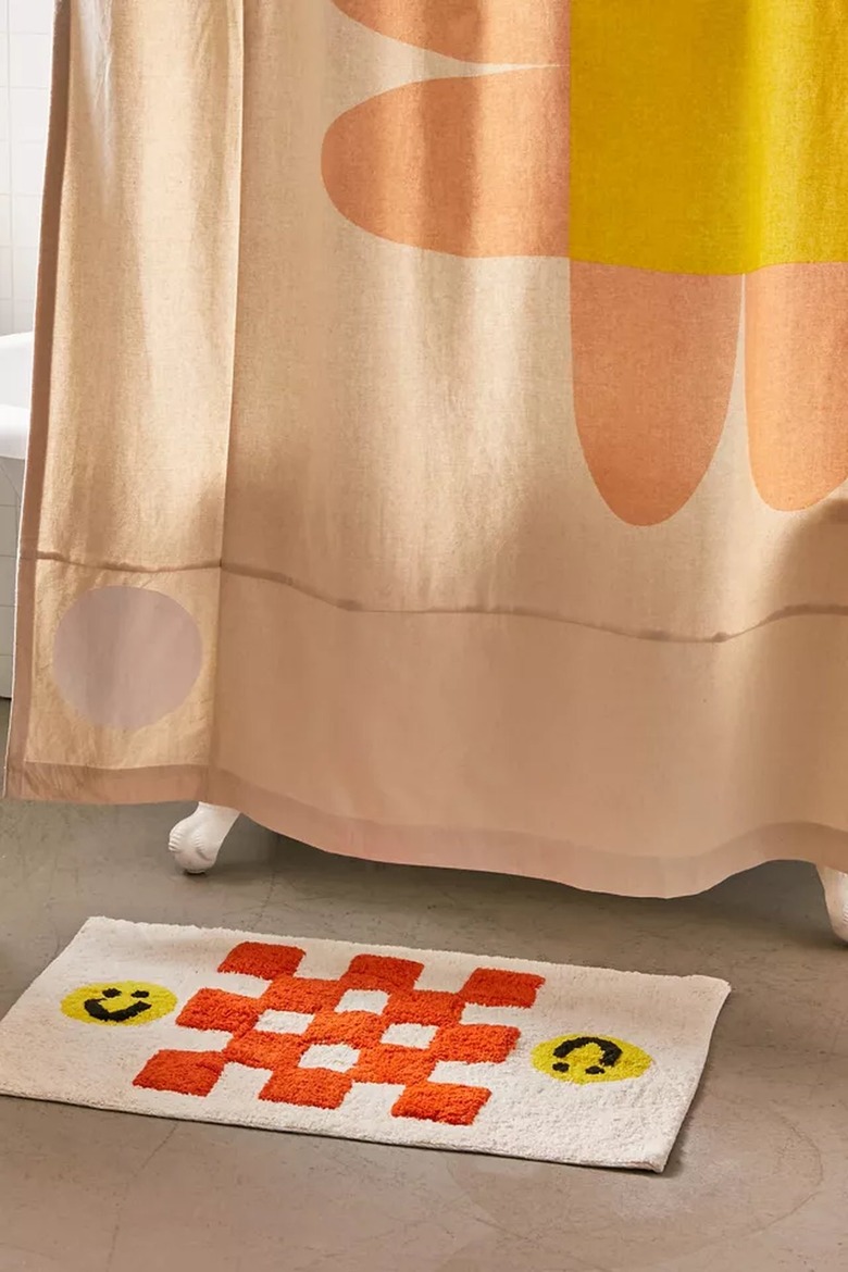 shower curtain with flower near bath mat with checkers and smiley faces
