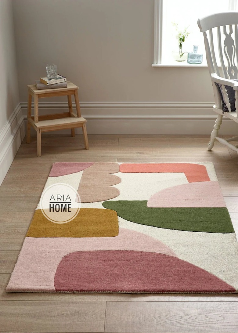 area with tufted rug in abstract pattern