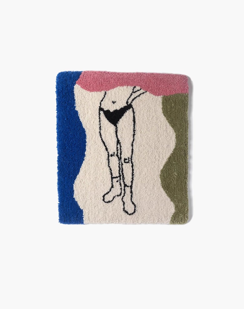 tufted rug with multiple colors and outline of the bottom half of a person's body