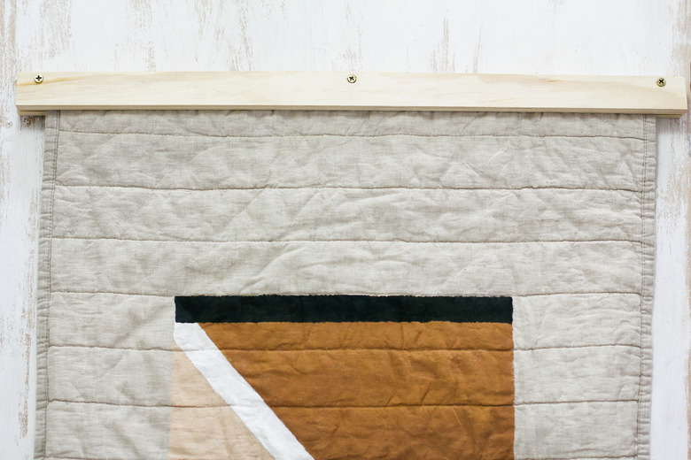 Brass screws attached through the two boards