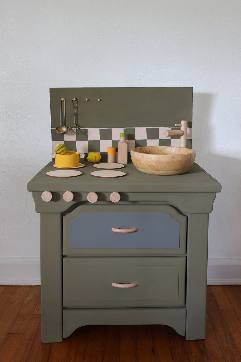 DIY olive green kids play kitchen with checkerboard backsplash and blonde wood accents