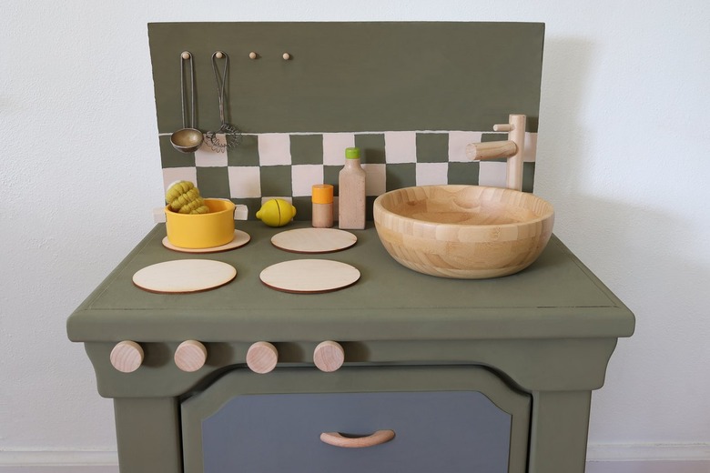 DIY olive green kids play kitchen with checkerboard backsplash and blonde wood accents