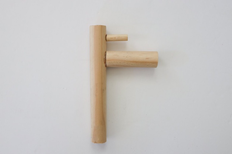 Wood dowel pieces cut and glued to create a toy sink faucet