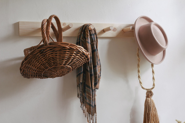 DIY wooden peg rail on wall with baskets