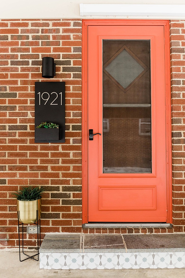 Front entrance of a house with an orange door