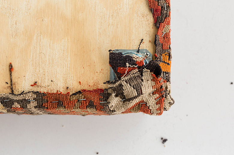 Use the idea of hospital corners to upholster around the corners of the board.