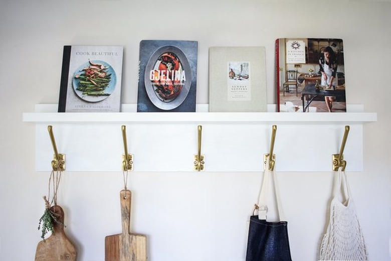 Marry the IKEA Mosslanda picture ledge with Kampig wall hooks to create a gorgeous wall organizer.