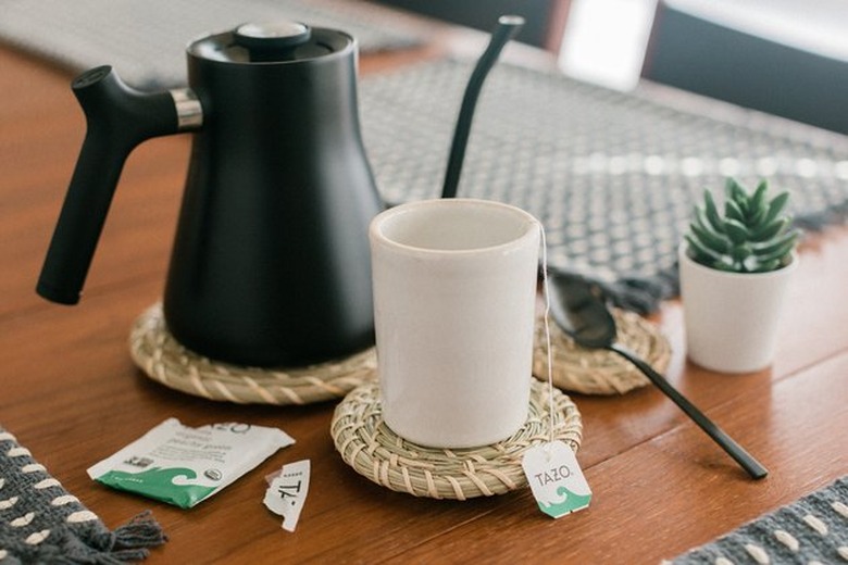 IKEA baskets coasters on coffee table with black coffee pot.