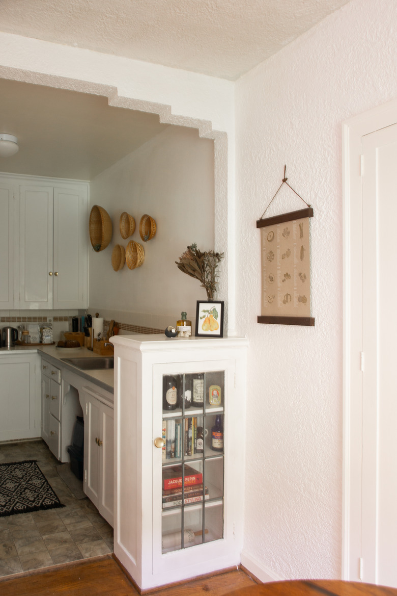 Kitchen view with hanging baskets on wall