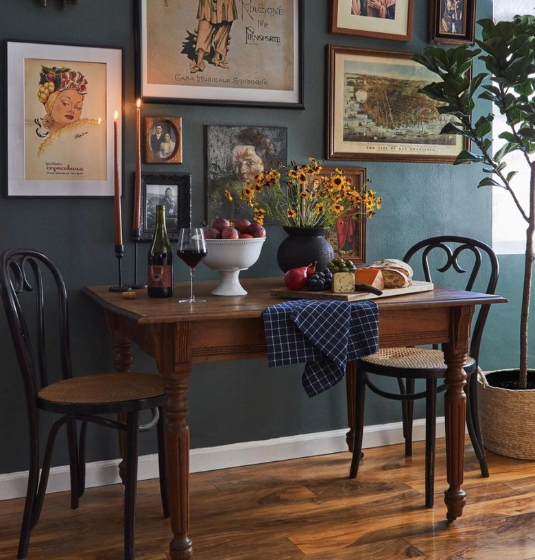 Dining area with teal walls.