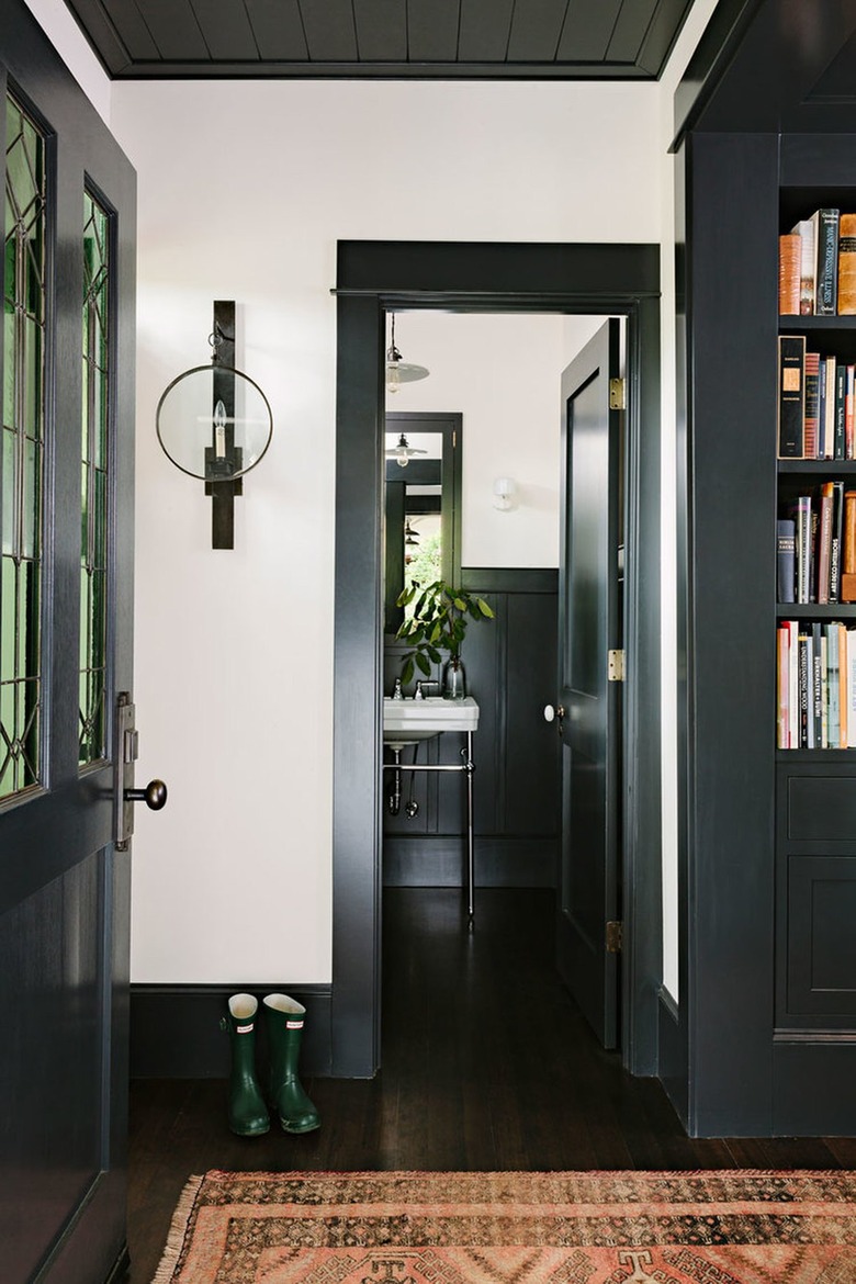 Hallway with black trim and dark wood floors.
