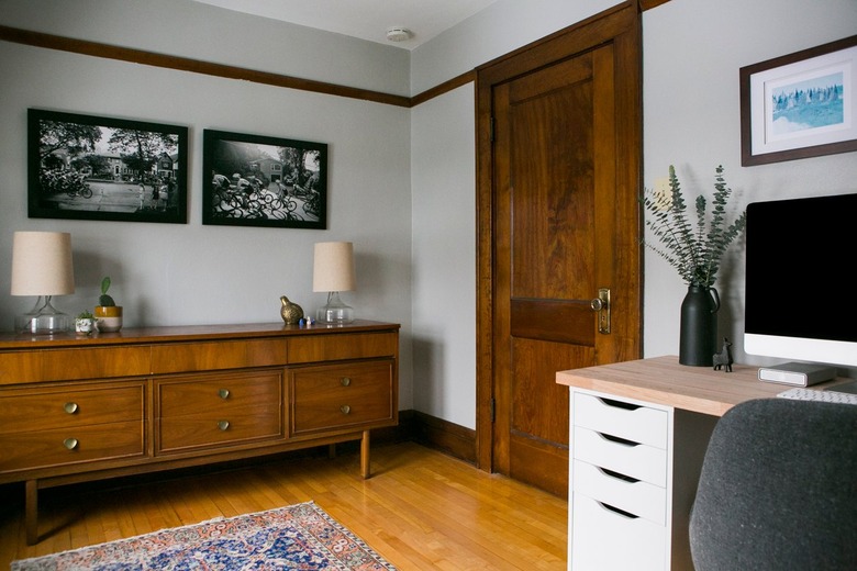 Home office with wood floors and wood trim.