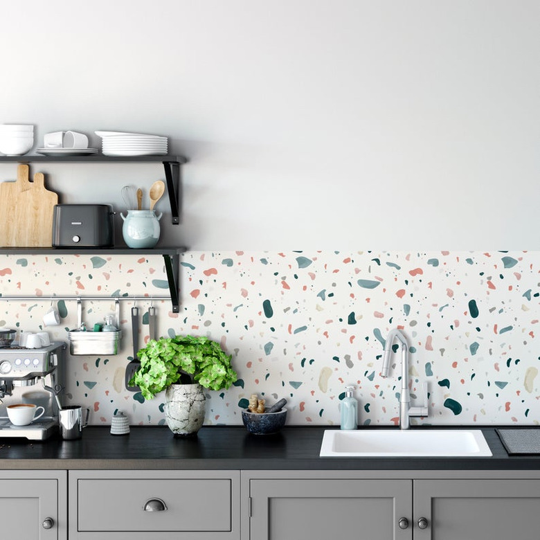kitchen wallpaper backsplash idea with terrazzo and black countertop