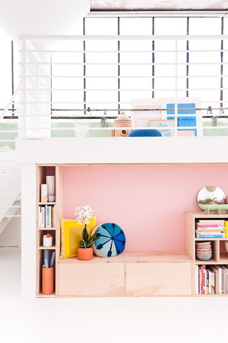 pink accent wall in reading nook in white room