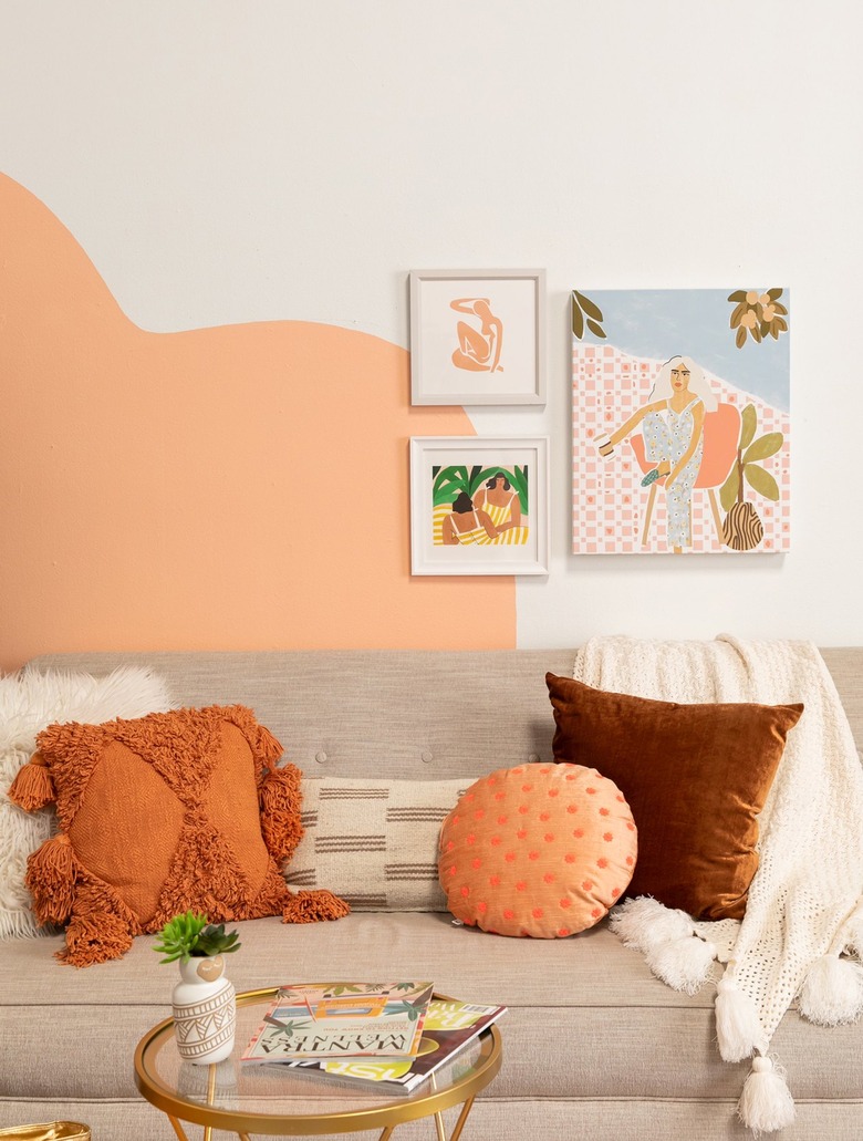 peach geometric wall accent with artwork in living room