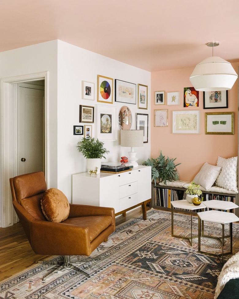pink and white living room with gallery wall