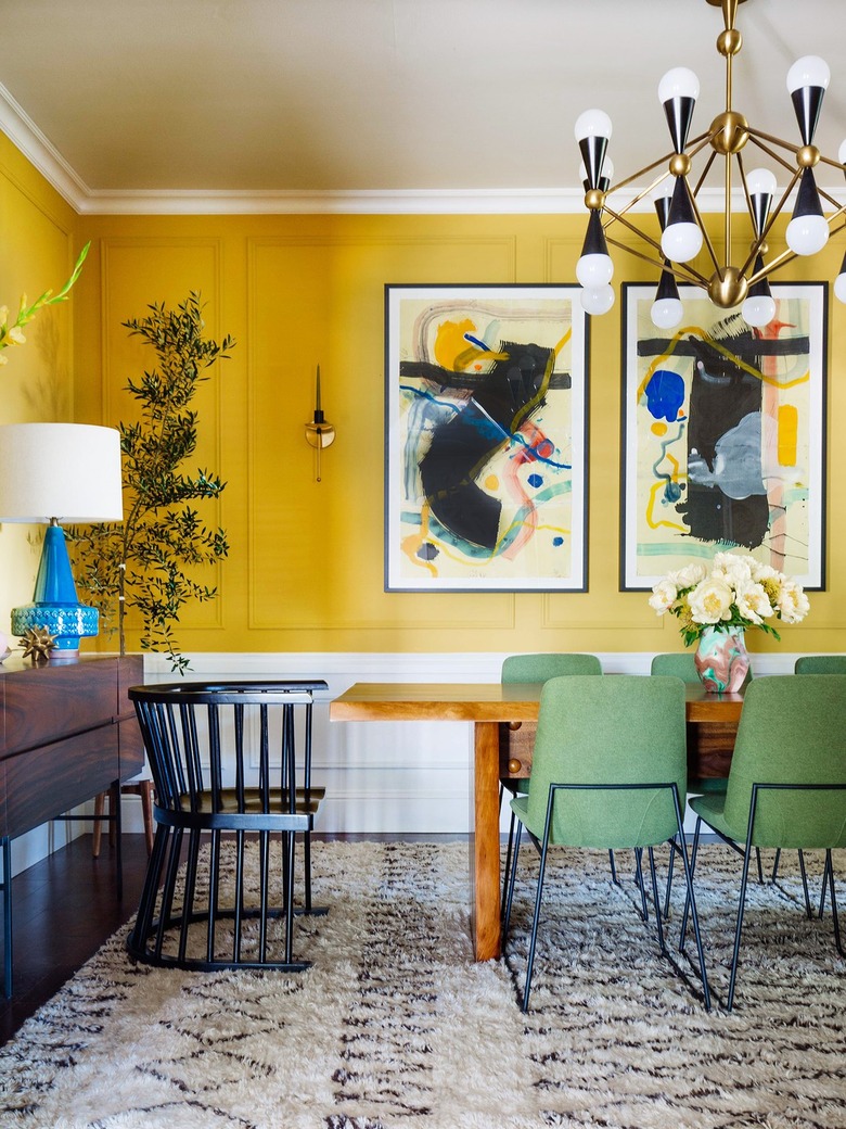 yellow and white dining room with midcentury decor