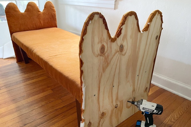 Attaching wavy bench arms to bench seat by drilling four screws through each arm and into the seat