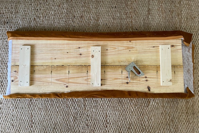 Upholstering the bench seat by stapling foam