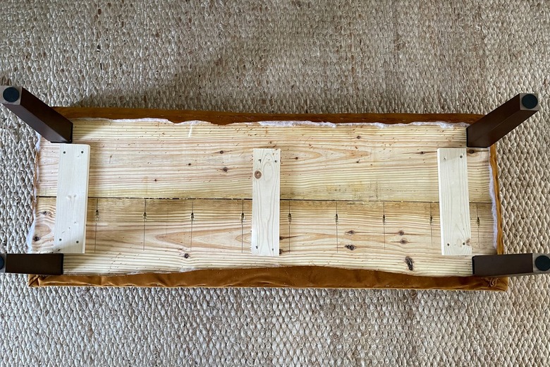 Four bench legs attached to underside of the bench seat