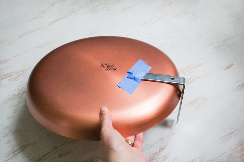 Round dish plate with blue painter's tape holding flat corner brace