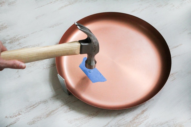 Hammer and round plate with blue painter's tape