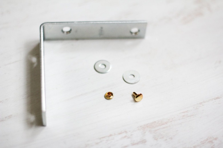 Flat metal brace with round washers and nails