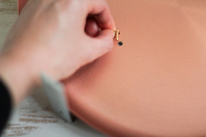 Round metal plate and small nail