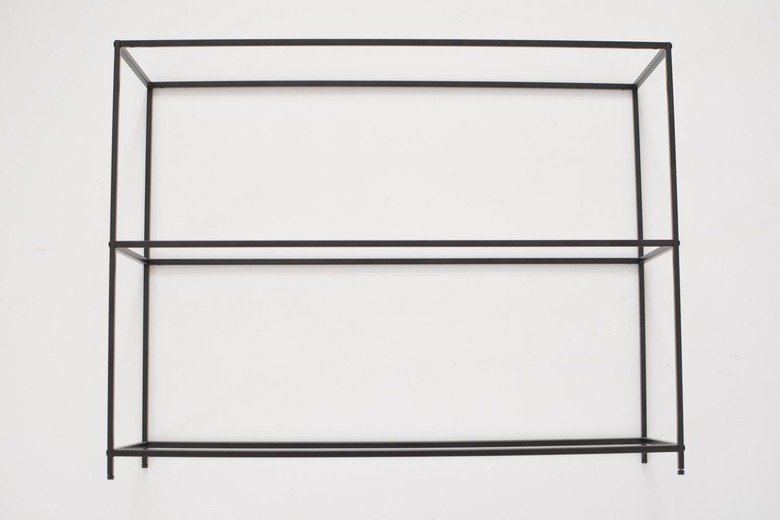 Black metal shelving frame against a white background