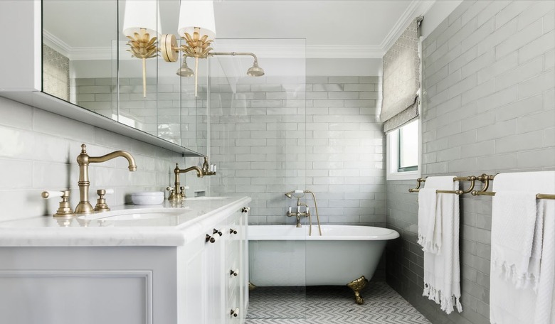 Wet room with gray tiled walls and club tub