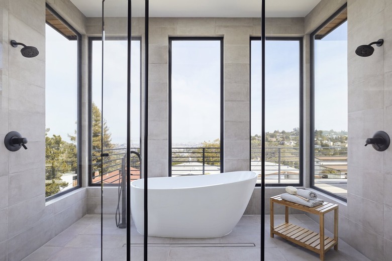 wet room with double showerheads and a freestanding tub