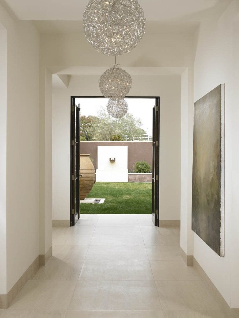 neutral toned hallway stone tile baseboards san diego home