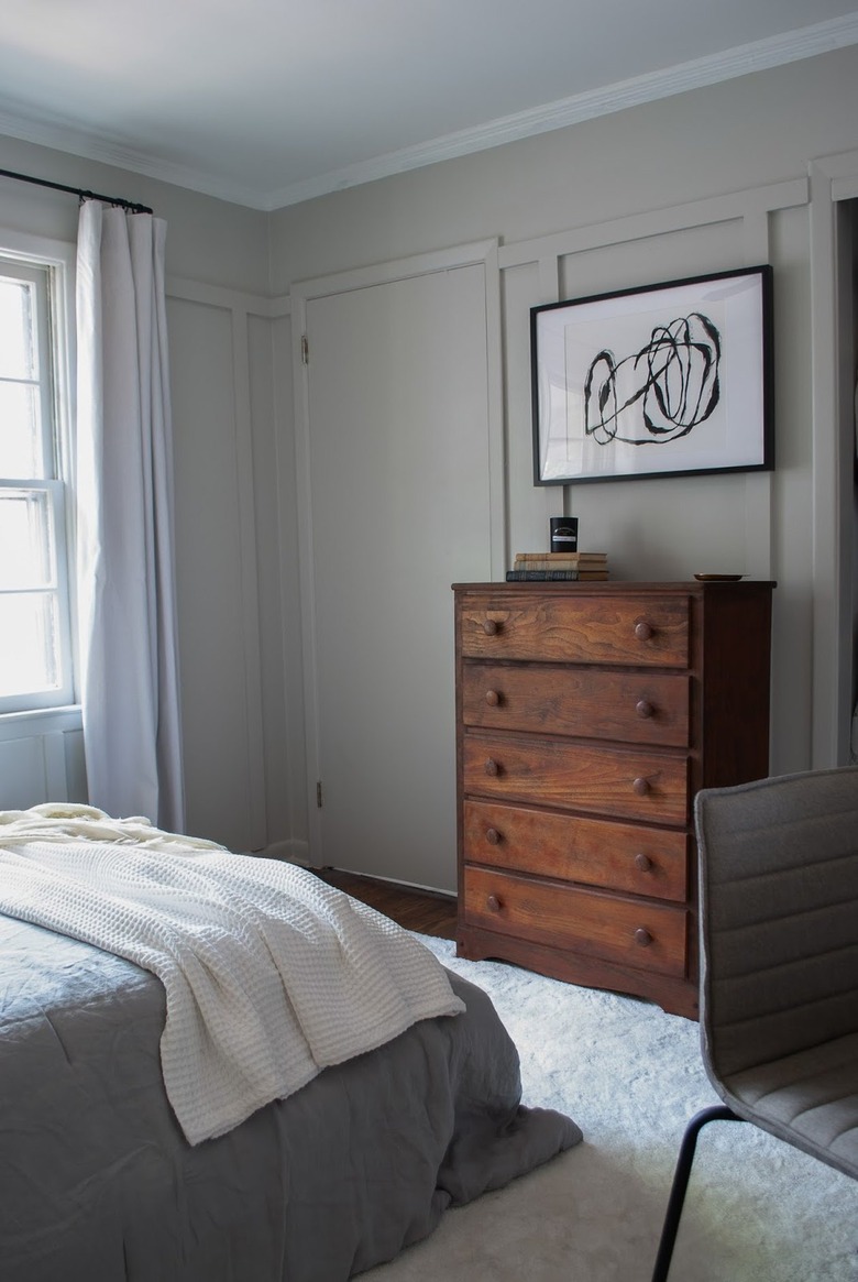walnut dresser in gray bedroom