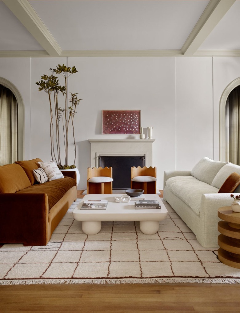 living room with ochre and ivory sofa and ivory rug