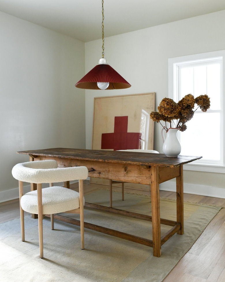 office with red pendant and artwork and ivory walls