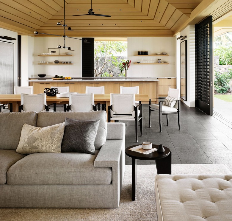 living room with gray sofa and beige rug