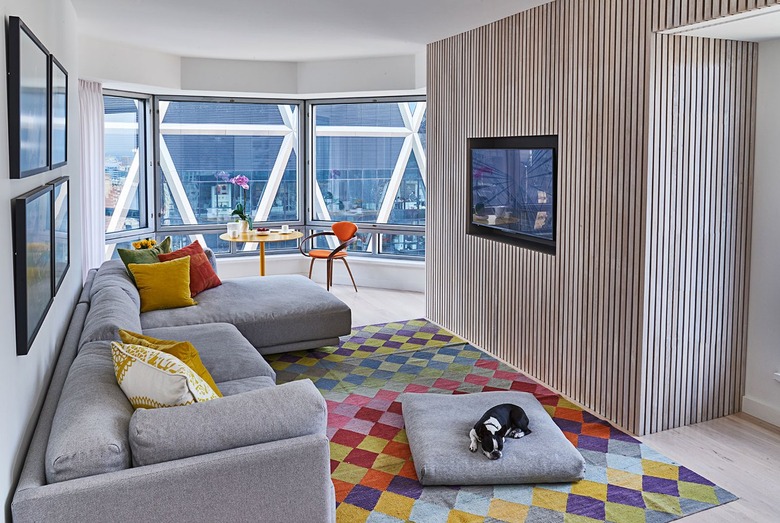 Gray couch with multi-colored rug