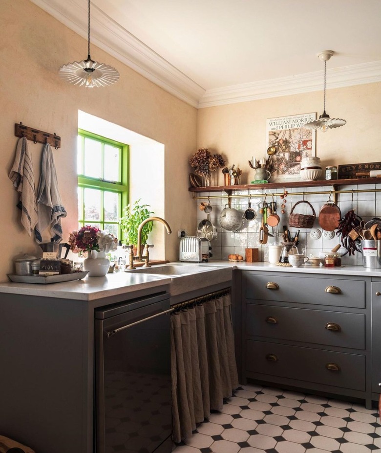 Kitchen with gray cabinets and peach walls.