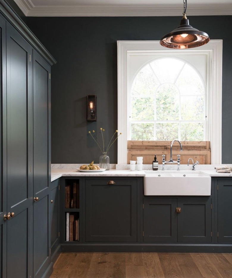 Kitchen with dark gray cabinets and dark gray walls.