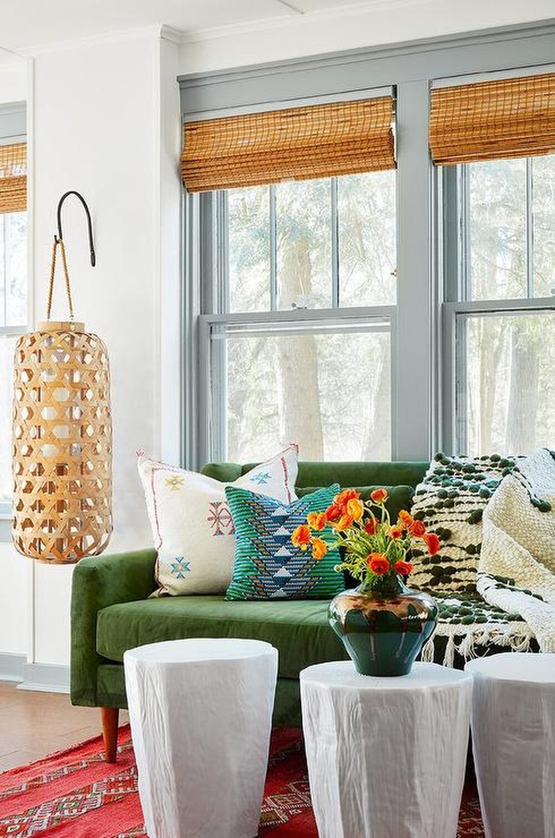 Living room with natural blinds and red rug